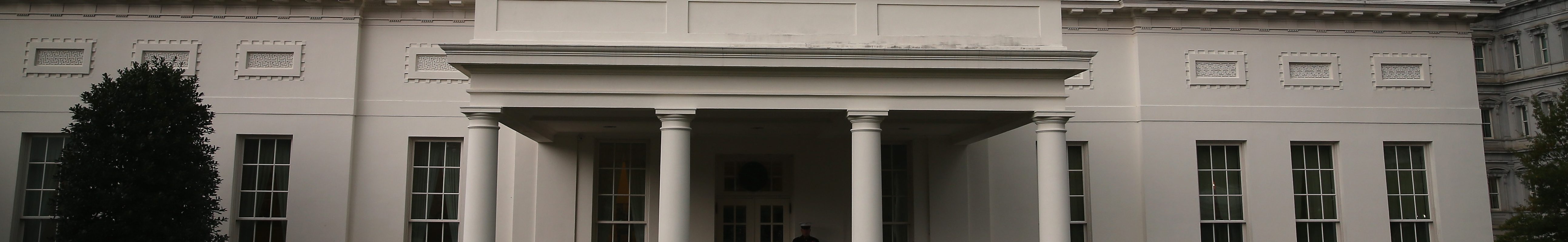 The White House as seem from outside the West Wing. A guard stands at the entrance.