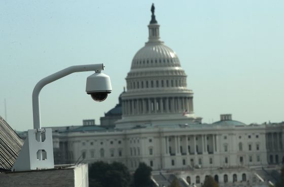 As the U.S. Capitol is seen in the background, a CCTV camera is mounted on a building roof November 3, 2017 in Washington, DC.