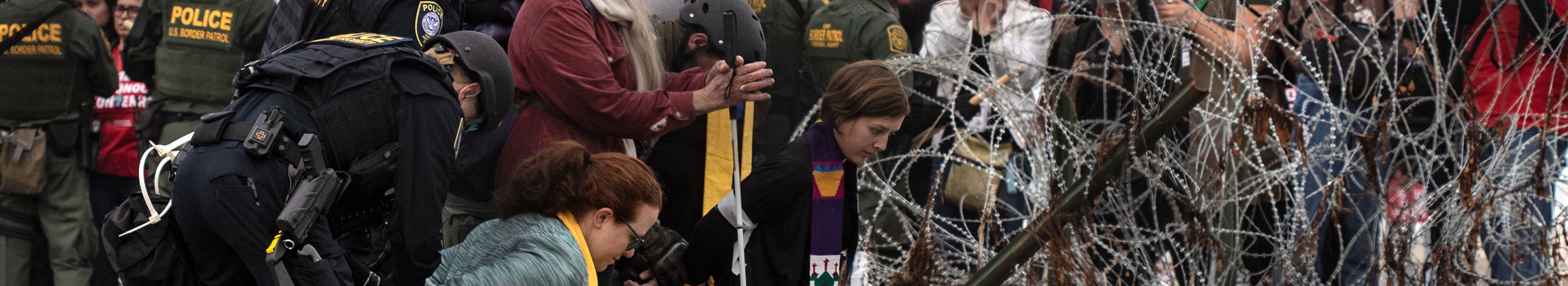 Police arrest activists demonstrating against anti-immigration policies near the US-Mexico border fence at Imperial beach in San Diego county, US on December 10, 2018.