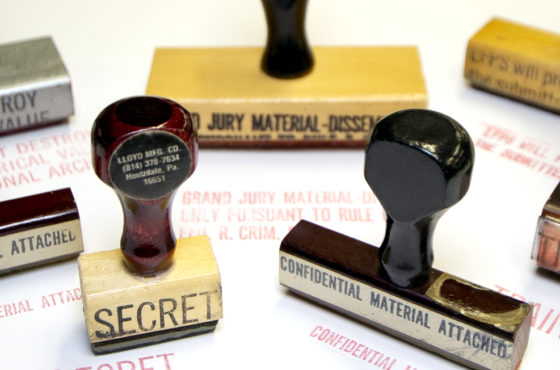 A collection of FBI rubber stamps reading, “Secret,” “Top secret material attached,” “Confidential material attached,” “Training,” and more.