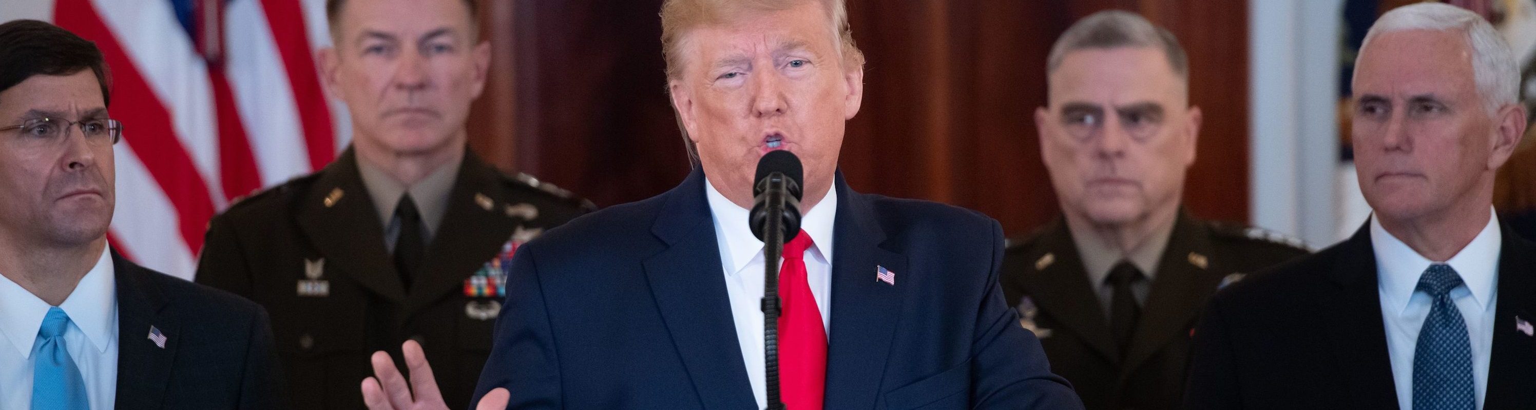 Trump speaks from the White House on January 08, 2020 in Washington, DC. Pence, Esper and others stand around him.