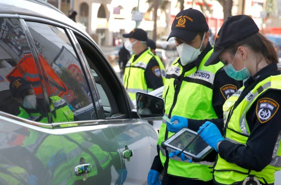 Israeli police stop a vehicle at a checkpoint in Bnei Barak