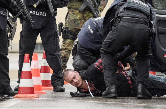 Members of the Bavarian police and the Bundeswehr, the German armed forces, intercept a vehicle and pin a man to the ground at a checkpoint during a demonstration as part of the GETEX anti-terror exercises during a media event on March 9, 2017 in Murnau, Germany.