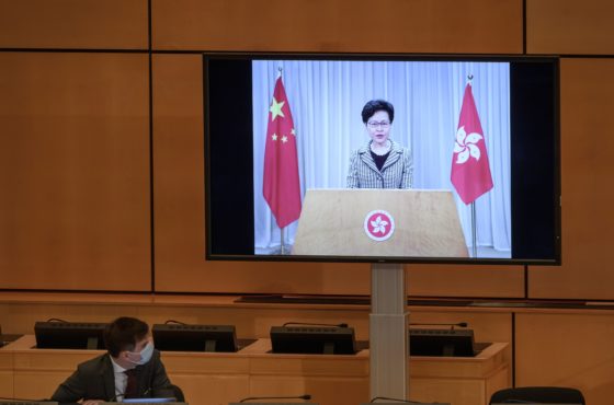 Hong Kong's chief executive Carrie Lam is seen on a giant screen remotely addressing the opening of the UN Human Rights Council's 44th session on June 30, 2020 in Geneva.