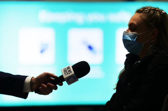A passenger in a face mask off a Melbourne to Sydney flight speaks to media at Sydney domestic airport on July 07, 2020 in Sydney, Australia.