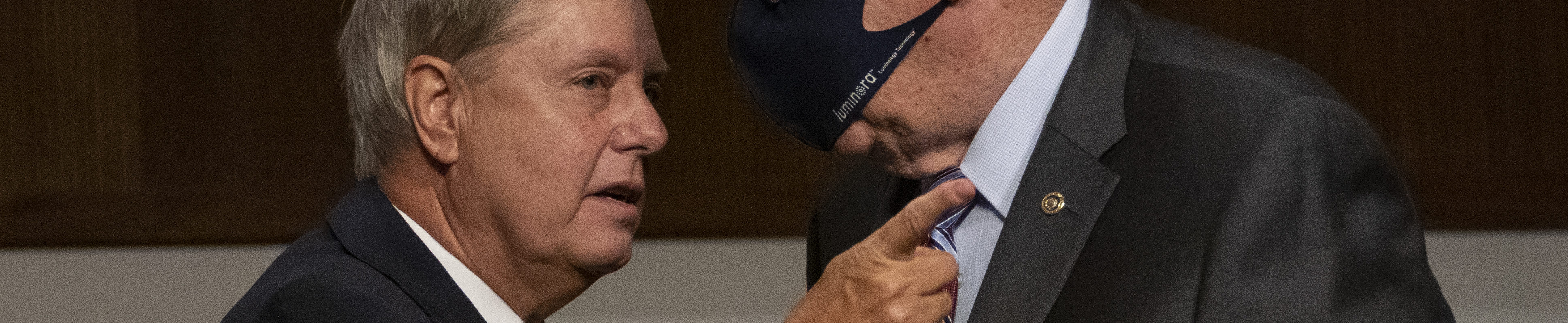 Chairman Sen. Lindsey Graham (R-SC) leans in close without a face mask to speak with Sen. Patrick Leahy (D-VT), who wears a face mask, during a Senate Judiciary Committee hearing on "Oversight of the Crossfire Hurricane Investigation" on Capitol Hill on August 5, 2020 in Washington, DC.