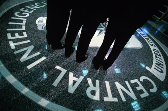 People stand on the CIA symbol on the floor of CIA Headquarters in Langley, Virginia.