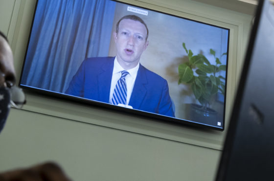 CEO of Facebook Mark Zuckerberg appears on a monitor behind a stenographer as he testifies remotely during the Senate Commerce, Science, and Transportation Committee hearing 'Does Section 230's Sweeping Immunity Enable Big Tech Bad Behavior?', on Capitol Hill, October 28, 2020 in Washington, DC.