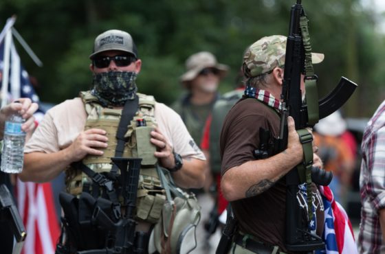 Armed members of far right militias and white pride organizations rally near Stone Mountain Park in downtown Stone Mountain, Georgia on August 15, 2020.