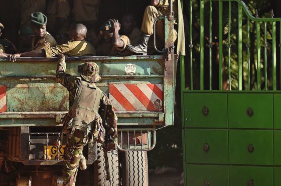 A member of Kenya Defence Forces boards a truck carrying Kenyan Police as it enters the university campus of the northeastern town of Garissa on April 3, 2015, one day after 147 people, mostly students, were killed when Somalia's Shebab Islamist group attacked the university.
