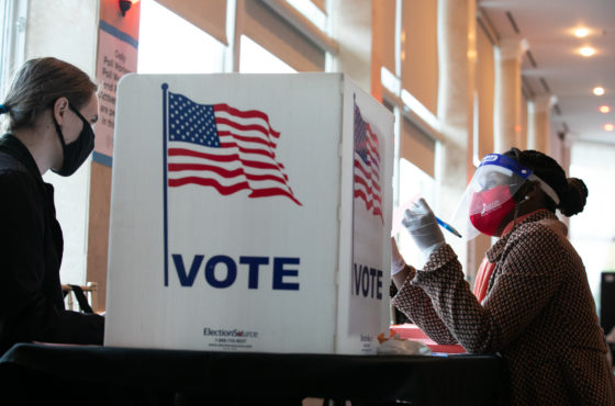 A poll worker helps a voter fill out a provisional ballot at Park Tavern polling station on November 3, 2020 in Atlanta, Georgia.