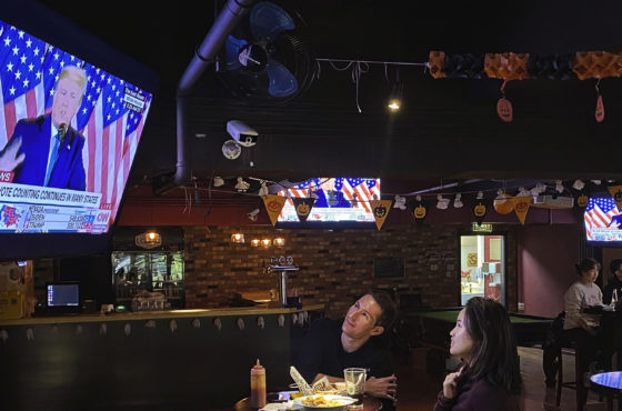 Customers watch a speech by U.S. President Donald Trump on a television during an election watching event at a local bar on November 4, 2020 in Beijing, China.
