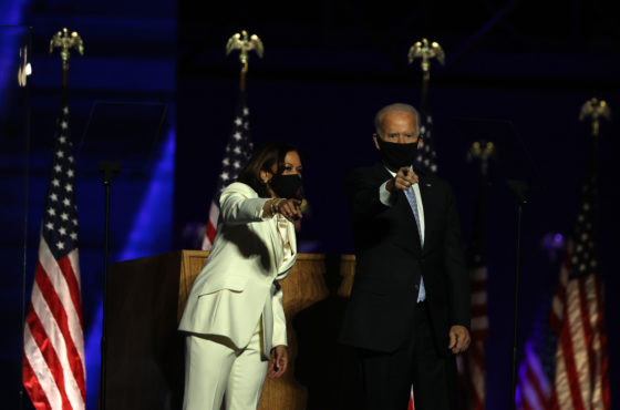 US President-elect Joe Biden and Vice President-elect Kamala Harris stand onstage greeting the crowd in Wilmington, Delaware, on November 7, 2020, after being declared the winners of the presidential election.