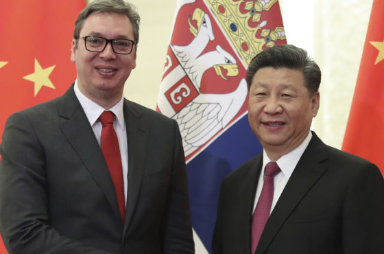 Serbian President Aleksandar Vucic shakes hands with Chinese President Xi Jinping before the meeting at the Great Hall of People in Beijing, China on April 25, 2019. Country flags are lined behind them.