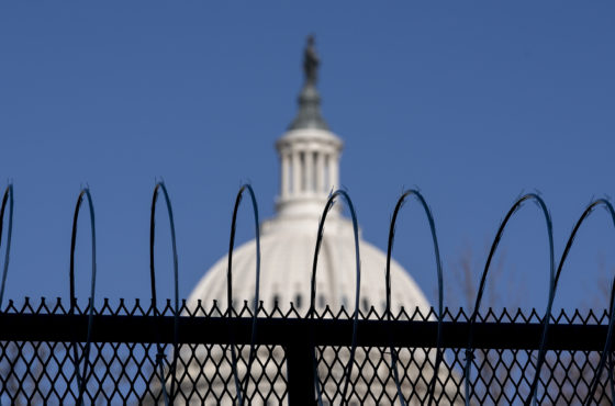 The dome of the U.S. Capitol building is seen behind a barbed wire fence on January 14, 2021. The barbed wire was installed after the attempted coup on January 6, 2021.