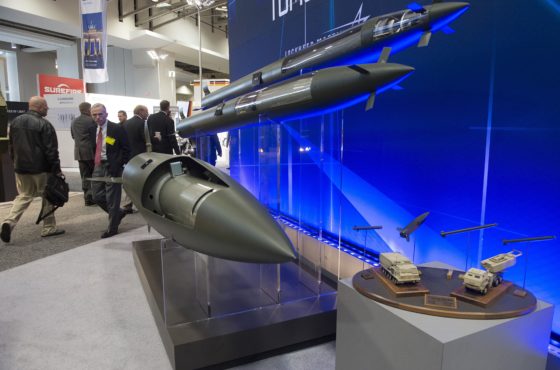 People walk past missiles manufactured by Lockheed Martin displayed during the Association of the United States Army (AUSA)Annual Meeting and Exposition in Washington, DC, October 13, 2014.