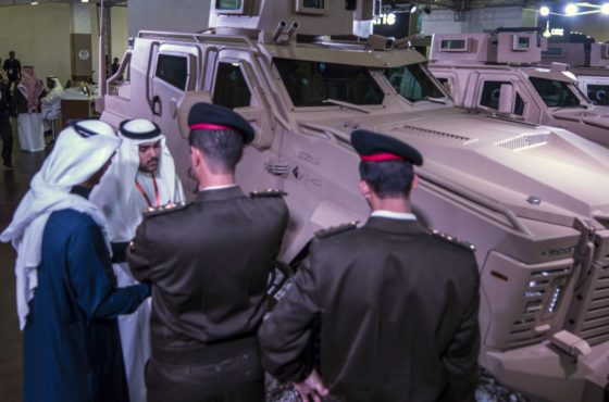 Egyptian military officers talk with Saudi men at the Saudi stand during Egypt’s first Service Defence Exhibition in Cairo on December 3, 2018, at the International Exhibition Center. Armored military vehicles are on display in the room they speak in.