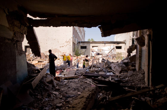 Georgian families visit the remains of their homes that were bombed by Russian aircraft August 28, 2008 in Gori, Georgia. Debris litters the floor. Buildings are missing walls and ceilings appear to be collapsing.