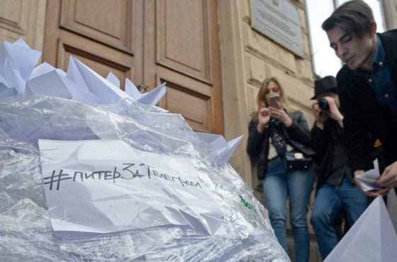 An activist of Vesna (Spring) youth movement fills a bag with two thousand paper planes, as a symbol of Telegram, during a flash-mob near the Roskomnadzor building in Saint Petersburg on April 13, 2018, as they protest against the blocking of the popular messaging app "Telegram" in Russia, after it refused to give state security services access to private conversations.