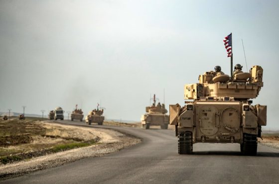 US soldiers in Bradley tanks carrying American flags patrol an area near Syria's northeastern Semalka border crossing with Iraq's Kurdish autonomous territory, on January 12, 2021.