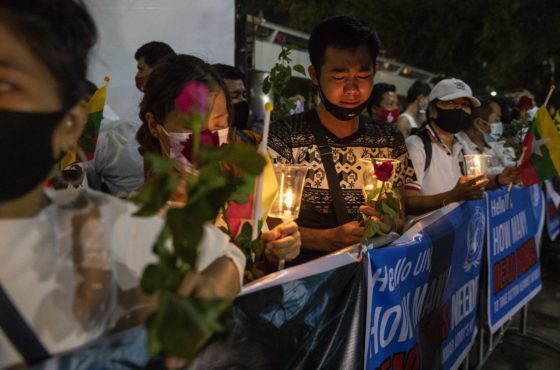 People gather at a candle-light vigil on March 04, 2021 in Bangkok, Thailand, for anti-coup protesters who have been killed in Myanmar following the military coup on February 1st. They carry flowers, candles, and flags and banners.