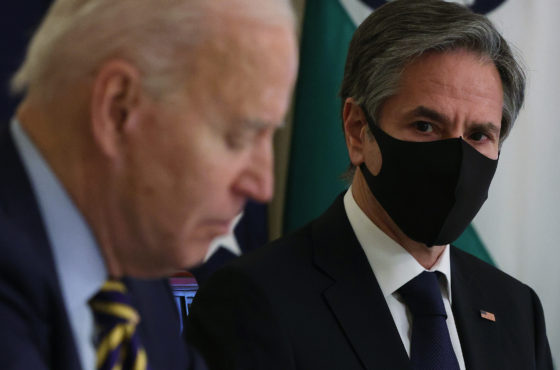 U.S. President Joe Biden, without a face mask, and U.S. Secretary of State Anthony Blinken, with a face mask, participate in a virtual meeting with leaders of Quadrilateral Security Dialogue countries March 12, 2021 at the State Dining Room of the White House in Washington, DC.
