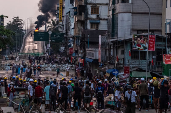 Smoke rises from tires burning at barricades erected by protesters after military junta forces attempted to attack them on March 16, 2021 in Yangon, Myanmar.
