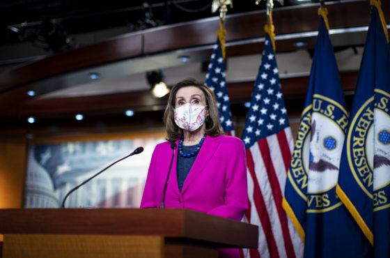 U.S. Speaker of the House Rep. Nancy Pelosi wears a face mask as she speaks at a weekly news conference at the U.S. Capitol on February 25, 2021 in Washington, DC. Behind her are American flags and flags for the House of Representatives.