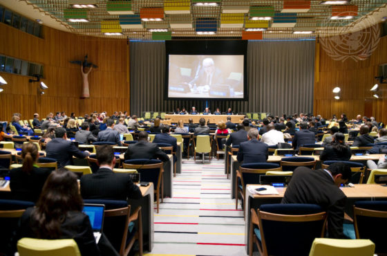 A wide view of the Trusteeship Council Chamber during a joint open briefing by the Chairs of Security Council committees engaged in countering the financing of terrorism, as well as by the President of the Financial Action Task Force (FATF), on their respective roles. The room appears to be full and a large projection screen shows a member sitting at the panel in the front of the room.