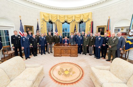 Trump hosts Department of Defense leadership at the White House on October 7, 2019. They pose for a picture in the Oval Office.