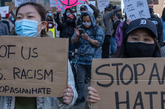People march during a Stop Asian Hate rally in downtown Detroit, Michigan on March 27,2021, as part of a nation wide protest in solidarity against hate crimes directed towards Asian Americans in the wake of the Atlanta, Georgia spa shootings that left eight dead. They carry signs reading, “All of us vs. racism #StopAsianHate” and “Stop AAPI Hate.”