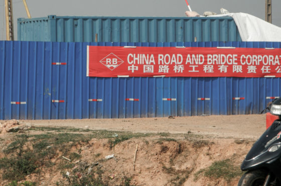 A person on a motorbikes drives next to the construction site of a new road built by the Chinese company China Road and Bridge Corporation (CRBC) in Antananarivo, on October 20, 2018.