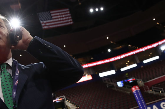 Paul Manafort, Campaign Manager for Donald Trump, speaks on the phone while touring the floor of the Republican National Convention at the Quicken Loans Arena as final preparations continue July 17, 2016 in Cleveland, Ohio. Seats are lined up in rows and a “Make America Great Again” sign is hung across the baseboards of the bleachers.