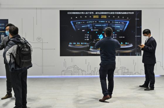 People wearing face masks visit a Huawei booth during the Mobile World Congress in Shanghai on February 23, 2021.