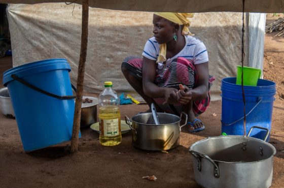 A woman cooks on the ground in the community of Ntocota, Metuge District in Pemba, Cabo Delgado Province on February 22, 2021, where thousands of displaced residents have been relocated due to recent attacks by armed insurgents in northern Mozambique.