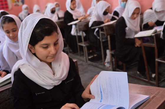 Girls attend their class at a school in Herat on May 9, 2021. A few wear face masks but many do not.