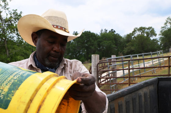 Handy Kennedy, founder of AgriUnity cooperative, prepares feed for his cows on HK Farms on April 20, 2021 in Cobbtown, Georgia.