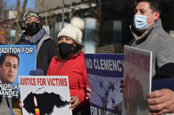 Demonstrators hold signs reading, “Narco Government makes the people emigrate;” “Extradition for Juan Orlando Hernandez;” “Justice for Victims;” “No Clemency for Narcos;” and more as they rally outside the Manhattan federal court in New York City on March 19, 2021 during the trial of Geovanny Fuentes Ramirez, a Honduran accused of drug trafficking and firearms possession. The demonstrators wear face masks due to COVID-19.